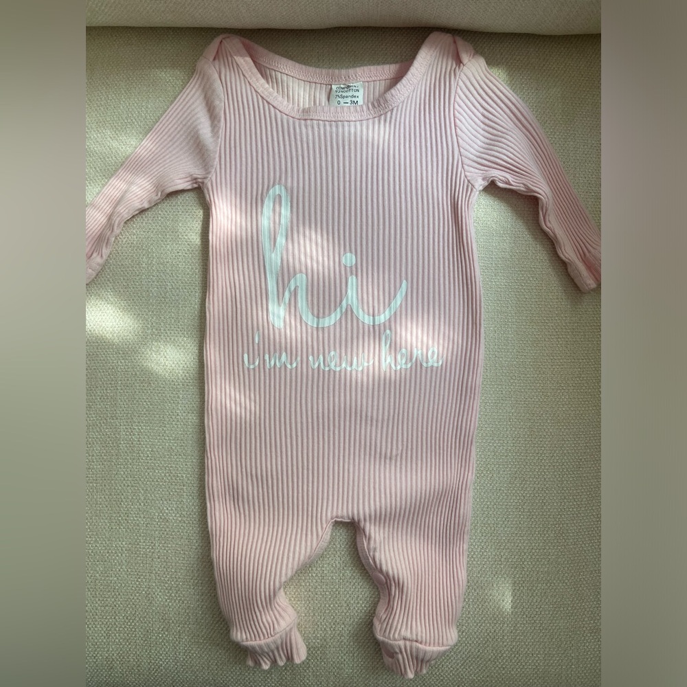 “Hi I’m new here” onesie. Used once.